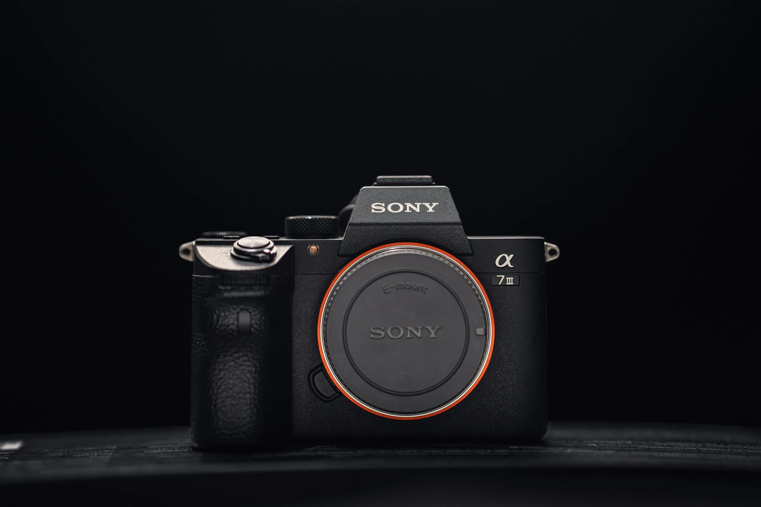 Sony A7 III Kameragehäuse von vorne vor dunklem Hintergrund