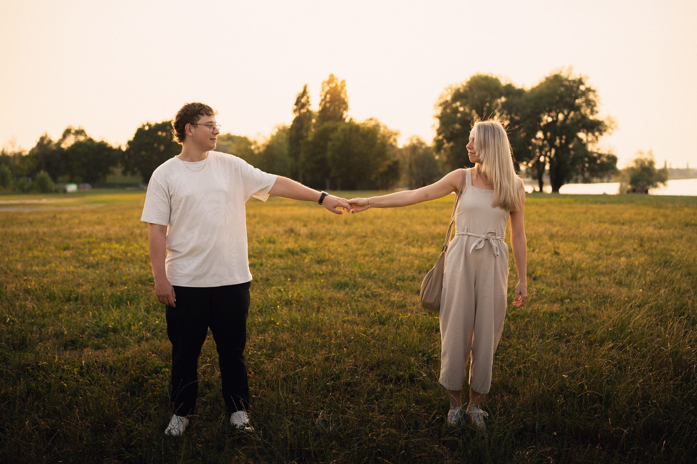 Luca und Natalie halten sich an einer Hand, weit auseinander auf der Wiese in Arbon